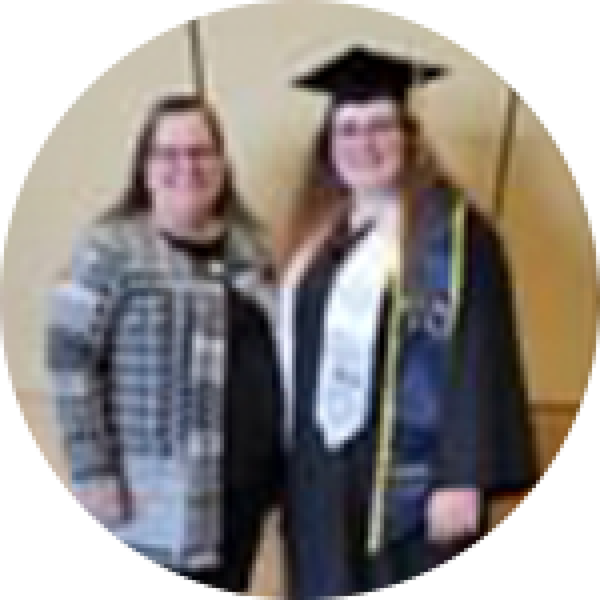 Two women in graduation gowns standing next to each other.